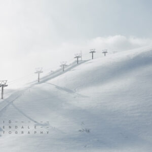 Happo-One #3 from the series The Fall 2016, Fine art print. A snow groomer travelling upwards on steep ski slope.