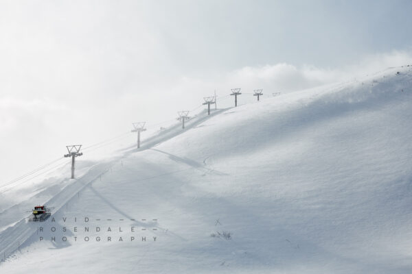 Happo-One #3 from the series The Fall 2016, Fine art print. A snow groomer travelling upwards on steep ski slope.