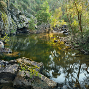 To lay a long time staring at the sun, fine art print. River and cliff face at sunrise